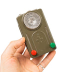 A person holding an original Swiss Army pocket signalling lamp, demonstrating its compact size and rugged olive-drab design.