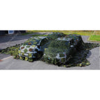 Front angle of Czech Army vehicle camouflage netting draped over cars