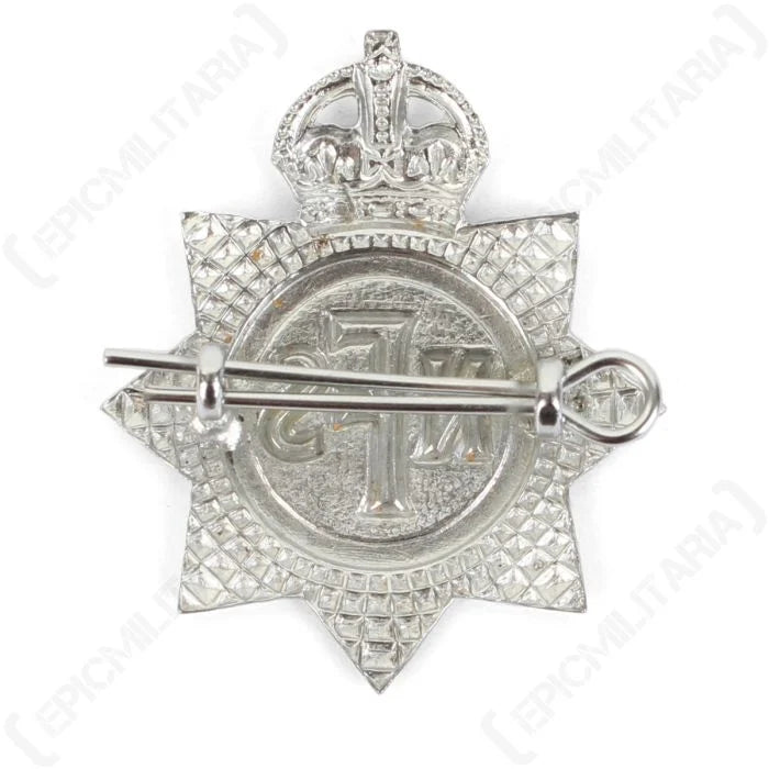 Reverse view of original NFS cap badge with steel split pin fitted through dual mounting lugs
