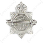 Reverse view of original NFS cap badge with steel split pin fitted through dual mounting lugs
