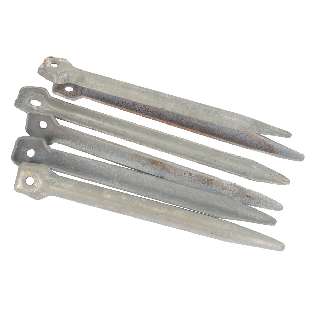 A collection of four vintage iron tent pegs from East German military surplus, showing authentic weathered texture and hexagonal heads.