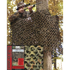 Camouflage netting deployed outdoors around a hunting tree hide stand
