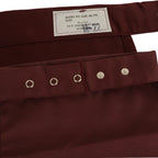 A close-up of the interior tag on a maroon US Army medical bib-style neckerchief with military specification details.