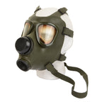 Three-quarter view of an original Romanian Army M74 gas mask on a display head, showcasing the olive neoprene rubber and dual eyepieces.