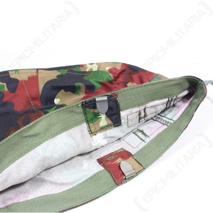 Interior view of Swiss M71 helmet cover showing herringbone cotton lining and metal spring attachment clips