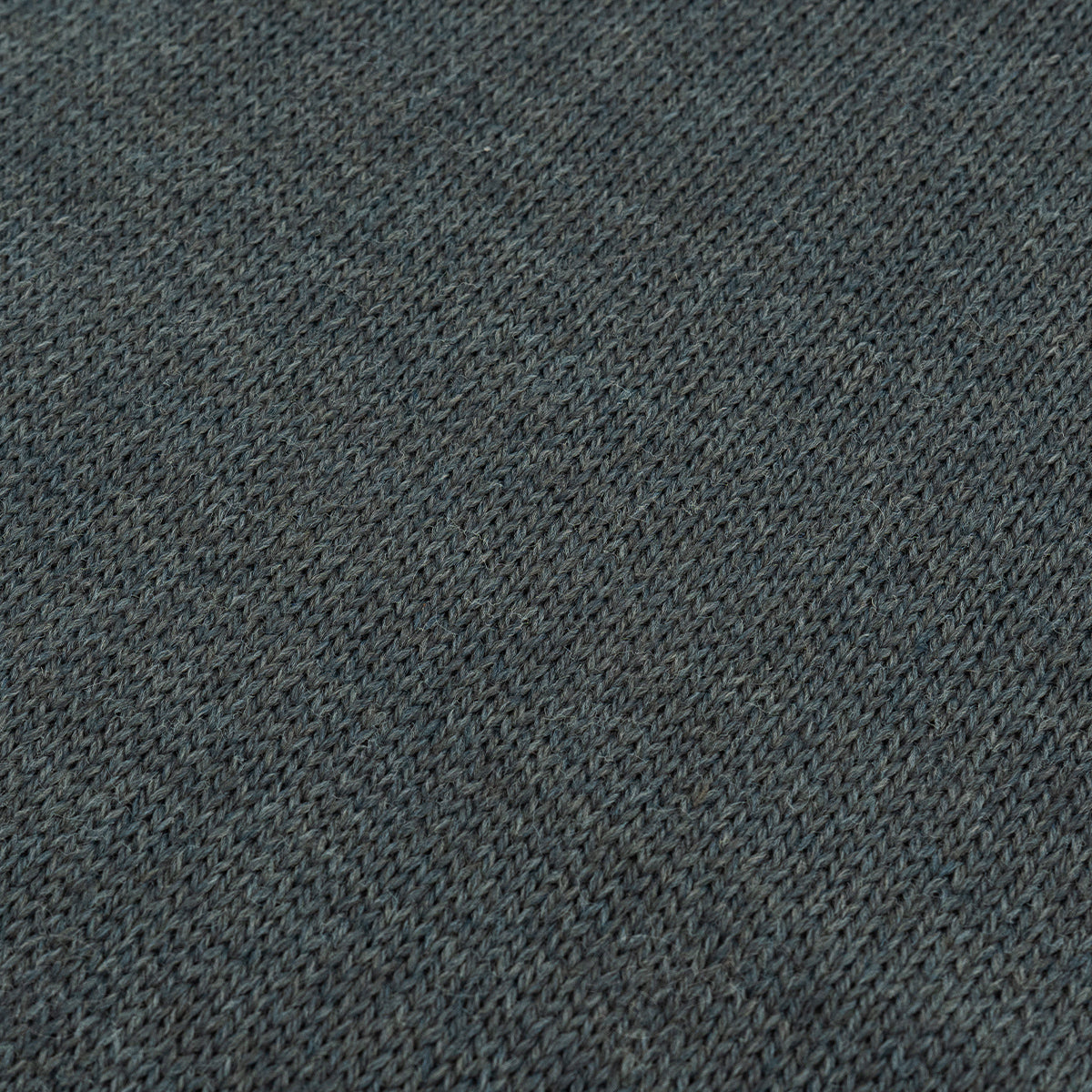 Close-up of the grey wool fabric texture illustrating the double-layered knit insulation of the Swedish military scarf.