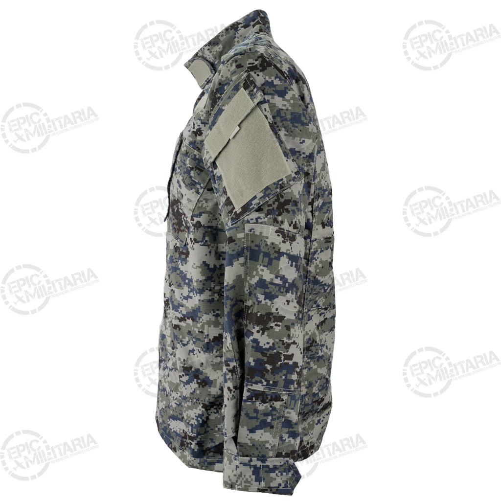 Side profile of an unissued Iraqi Police digital camo shirt showing the sleeve pocket layout and Velcro panels for attaching insignia.