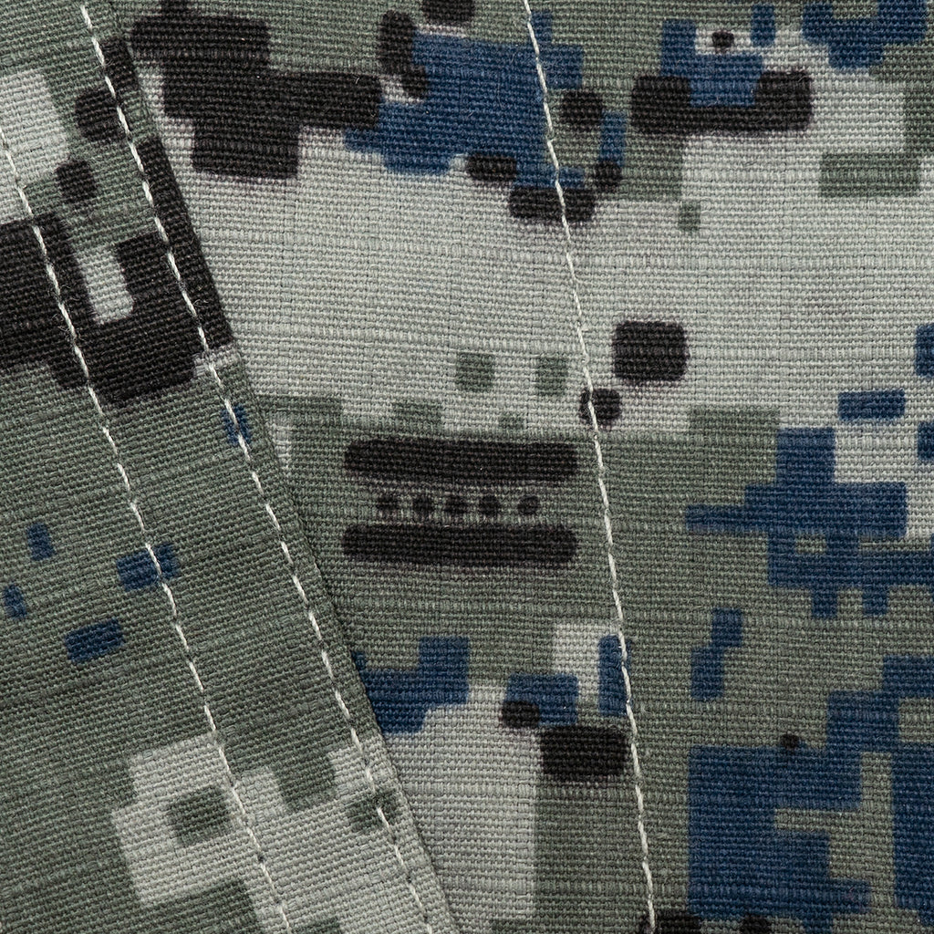Macro close-up of the polycotton ripstop fabric, clearly showing the texture and the detailed blue, black, and grey pixelated camo pattern.