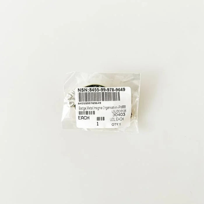 Original sealed military packaging with NSN 8455-99-978-9649 label for the PWRR cap badge