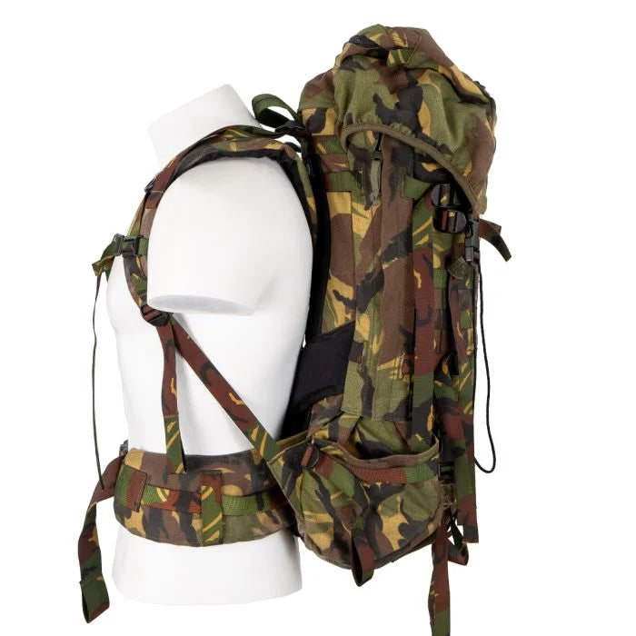 Side profile of the Dutch military 60L backpack, showing side zipper attachments for pouches and lower wand pocket.