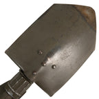 Detail view of the steel shovel head with visible wear, rivets, and textured locking collar for secure field positioning.