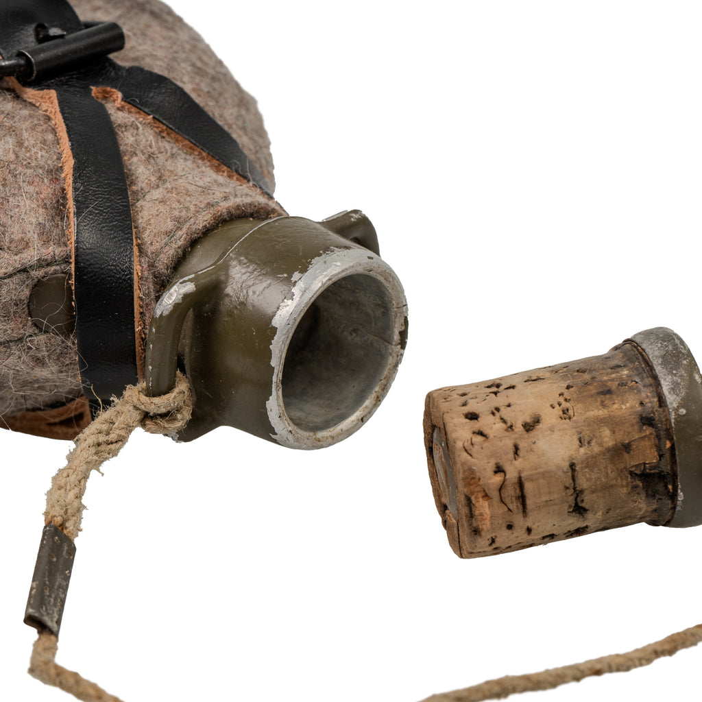 Close-up of the Czech M60 canteen bottle opening showing the tethered natural cork stopper for field use.