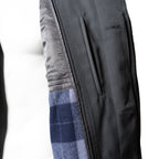 Close-up of the coat interior, revealing the distinctive blue and grey plaid wool lining and button-front construction.
