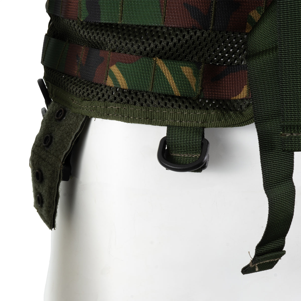 Bottom side detail of the woodland camo tactical vest showing reinforced D-rings and adjustable waist strap attachments.