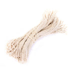 A bundle of eight natural fibrous army surplus rifle cleaning wicks tied together in an off-white color against a white background.