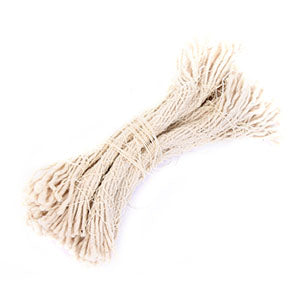 Isolated studio shot of a pack of unused army surplus rifle cleaning strings, showing the fibrous texture and knotted bundle structure.