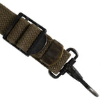 Close-up of the metal adjusting slider buckle and brass end tip on US Army M44 suspenders strap.