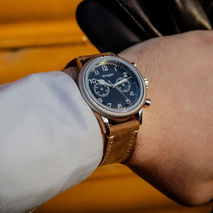 Ailager WW2 German pilot chronograph watch worn on a wrist with white shirt cuff