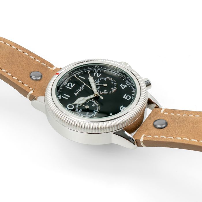 Angled side perspective showing the fluted timing bezel, red marker, and pushers on the pilot watch