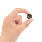 A hand holding a single 18mm field grey German button to demonstrate its small, versatile size for uniform repairs and costume design.