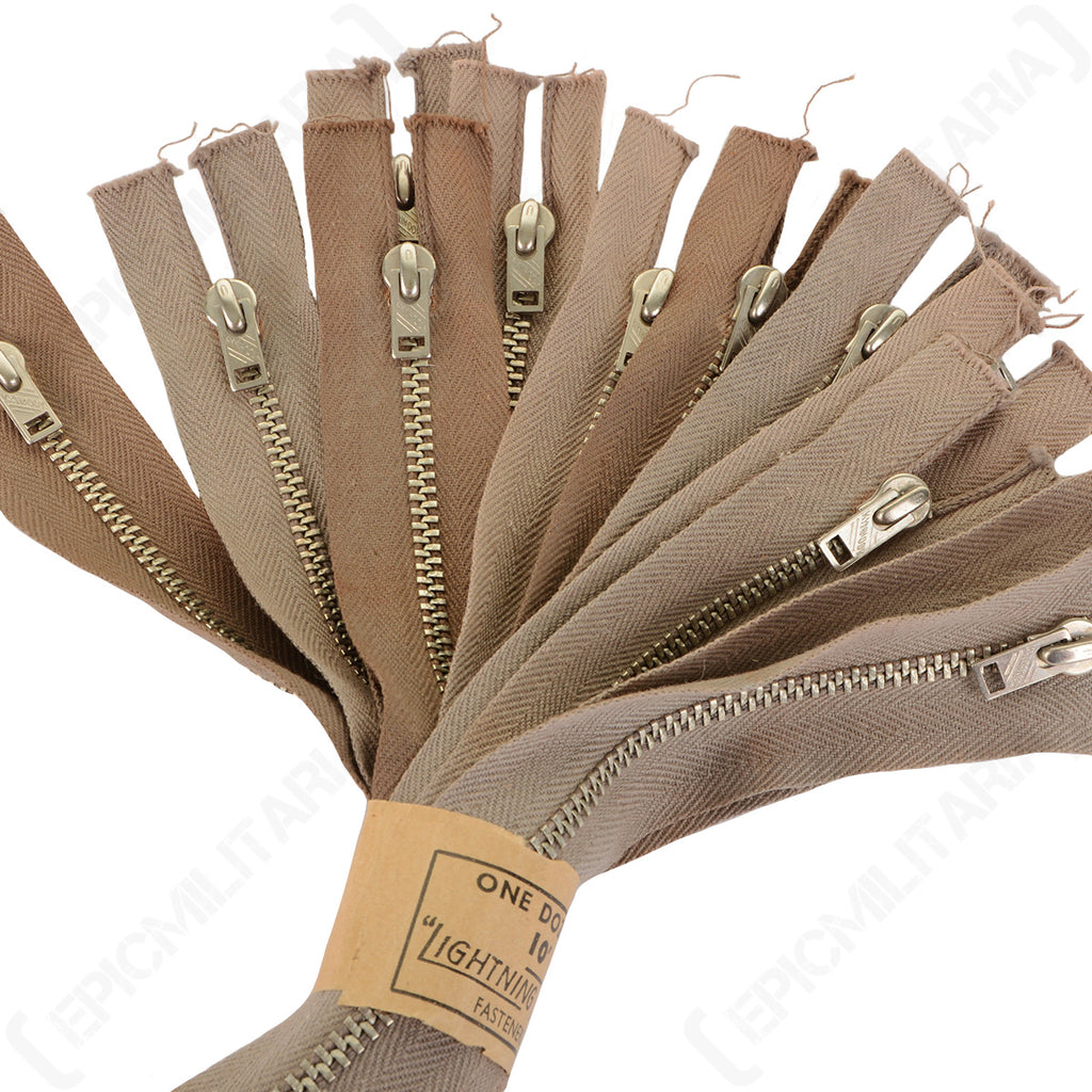 Close-up of a bundle of original Lightning Kynhook zipper fasteners highlighting the metal teeth and brown herringbone fabric tape texture.