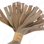 Close-up of a bundle of original Lightning Kynhook zipper fasteners highlighting the metal teeth and brown herringbone fabric tape texture.