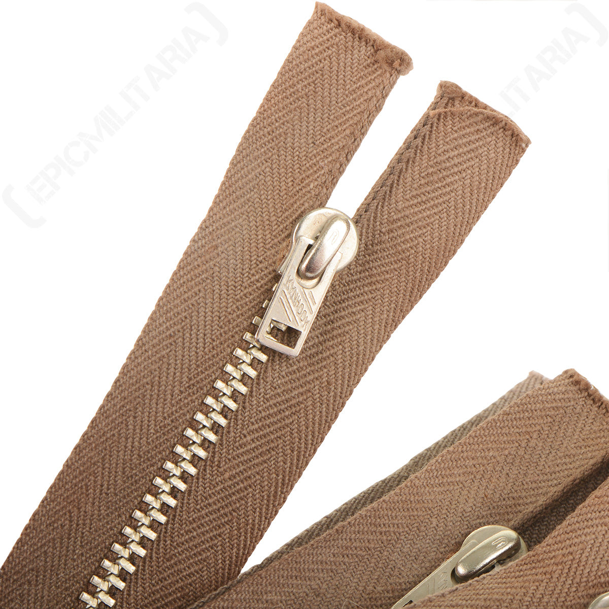 Macro detail of a Kynhook Lightning zipper pull showing metal construction and the herringbone weave pattern on the tape.