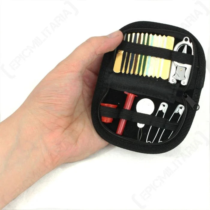 Tactical sewing kit open held in hand showing compact pocket size