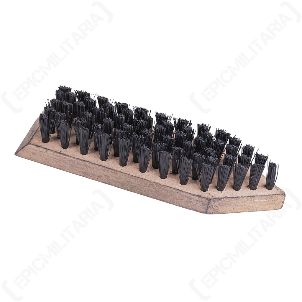 Close-up perspective of an unused Bundeswehr shoe brush highlighting the dense arrangement of stiff black bristles on a wooden base.