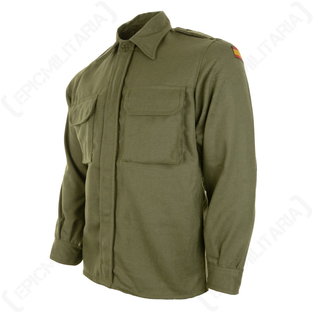 Angled view of an authentic olive green Spanish military shirt showing the left sleeve with an embroidered Spanish flag patch.