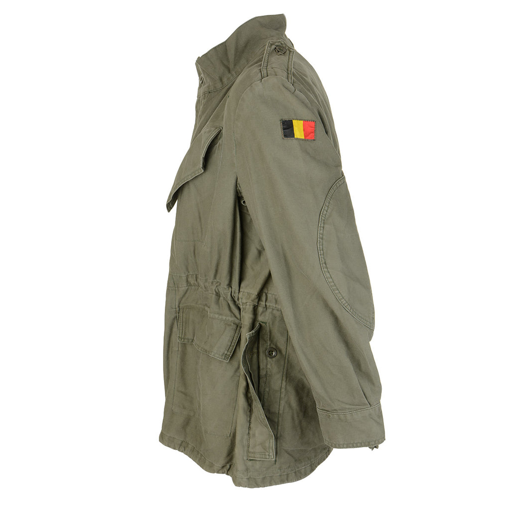 Side profile of the Belgian M88 olive green field jacket showing the reinforced elbow padding and shoulder construction.