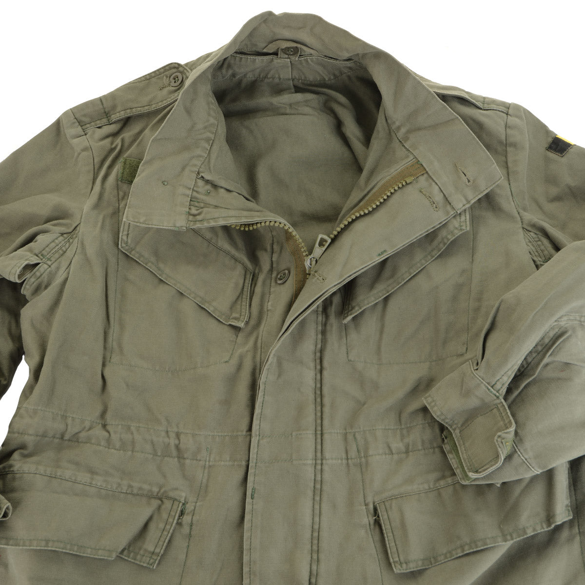 Close-up of the Belgian M88 jacket front, showing the heavy-duty metal zipper, secure wind flap, and chest utility pockets.
