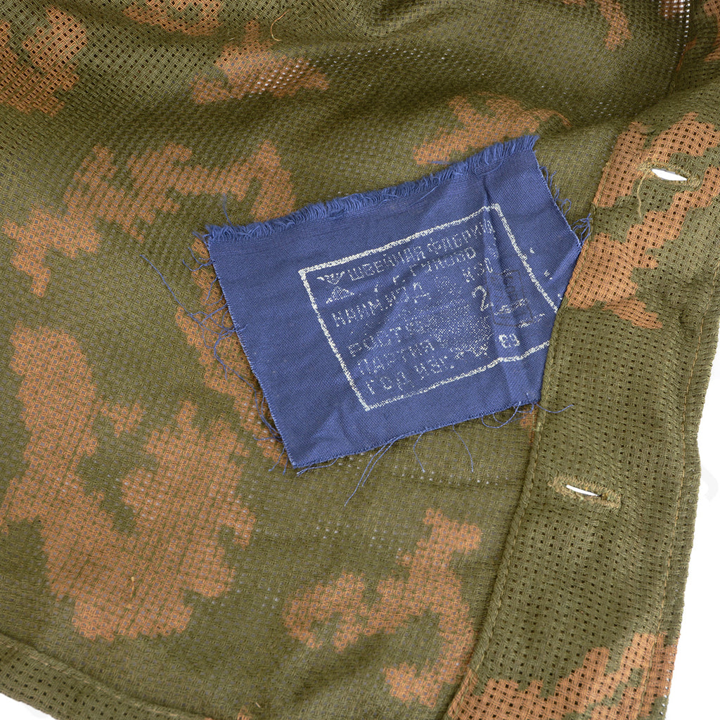 Close-up detail of the internal blue manufacturer tag on an authentic Soviet KZS sniper suit.