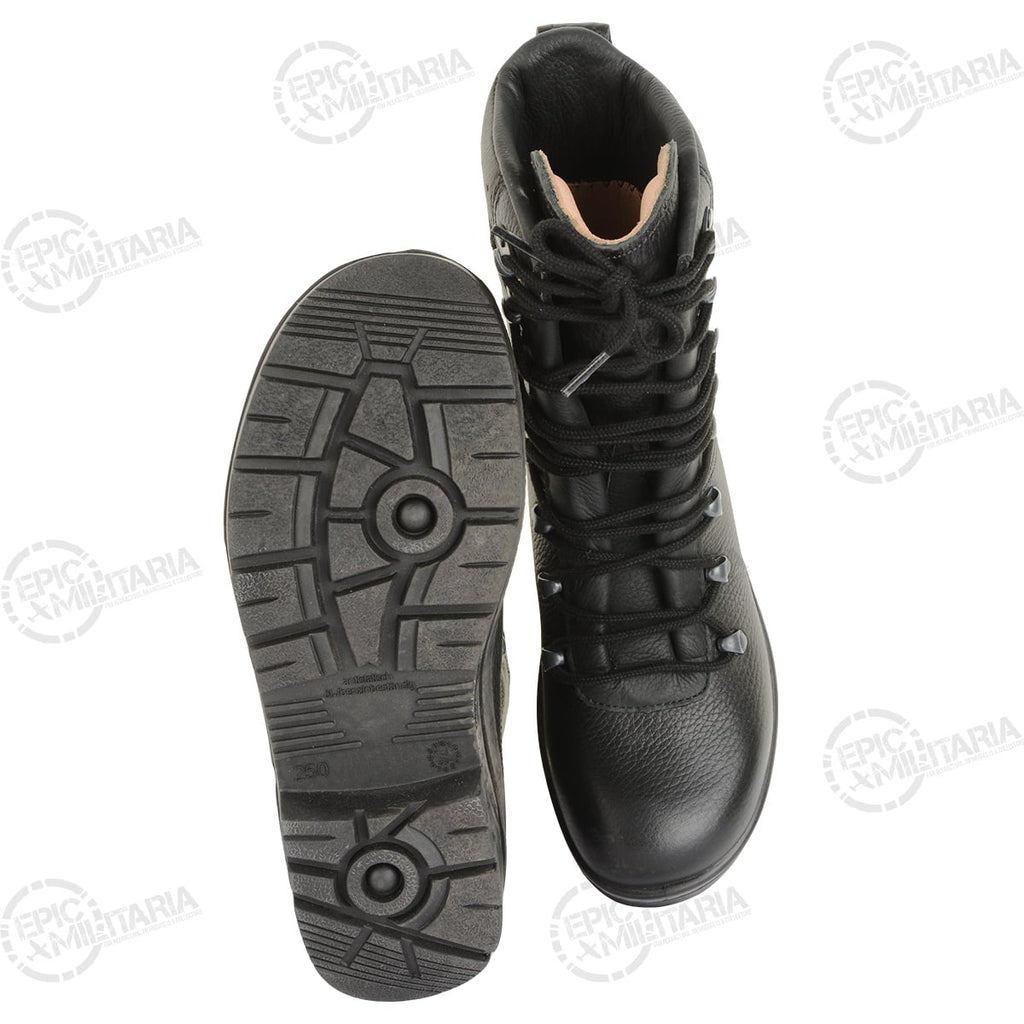 Top-down perspective of a pair of black leather German Army combat boots displaying the moulded non-slip soles.