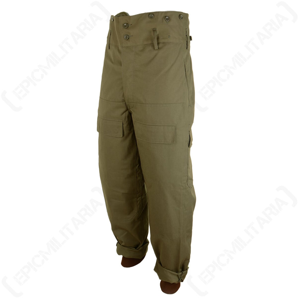 Three-quarter view of unissued Supergrade Czech M85 trousers showing cargo pockets and durable olive cotton construction.