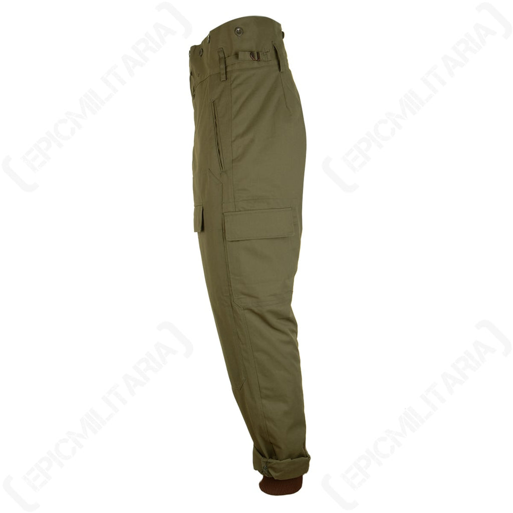 Side profile of authentic Czech M85 military trousers with adjustable waist straps and convenient cargo storage pockets.