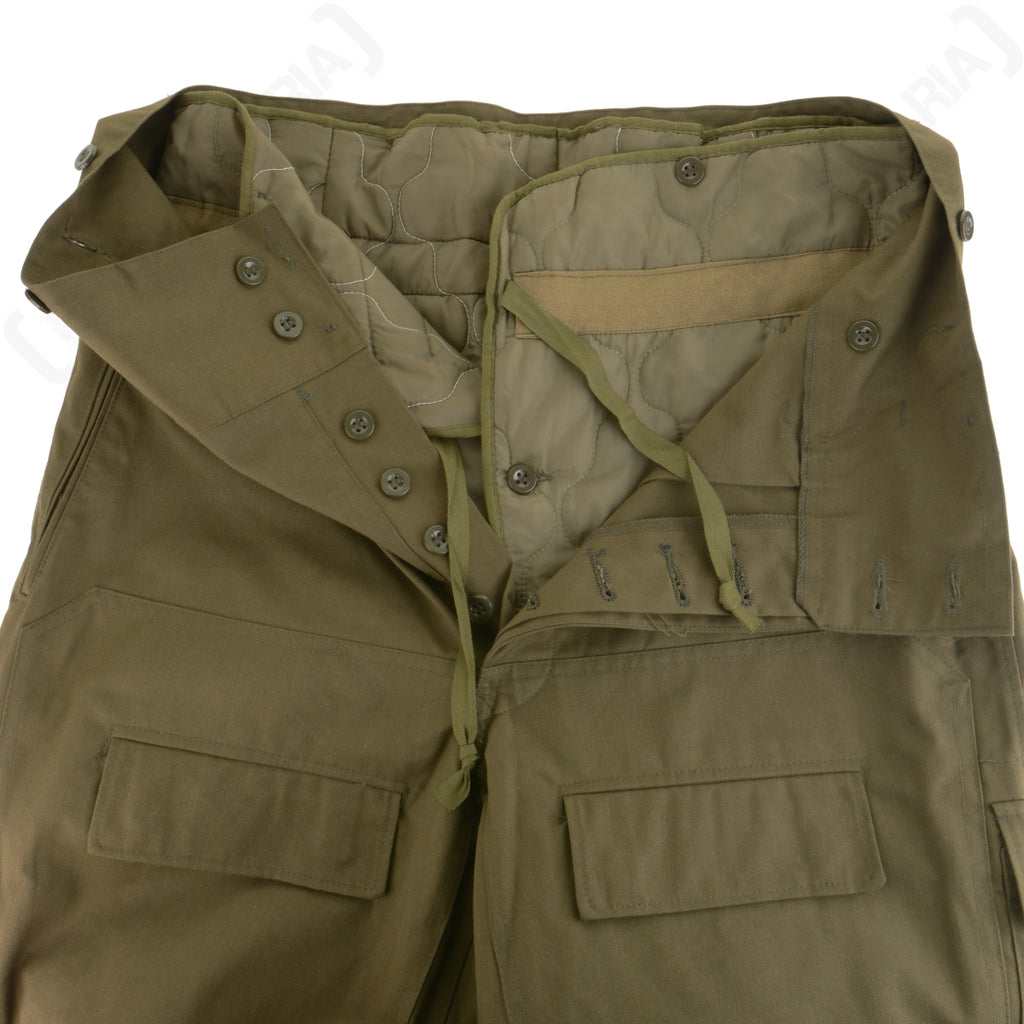 Interior view of Czech M85 trousers showing the removable quilted winter liner, button fly, and internal drawstring waist.