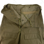 Interior view of Czech M85 trousers showing the removable quilted winter liner, button fly, and internal drawstring waist.