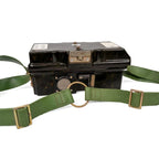 Front view of closed East German field phone showing latch and hand crank