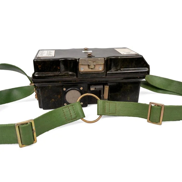 Front view of closed East German field phone showing latch and hand crank