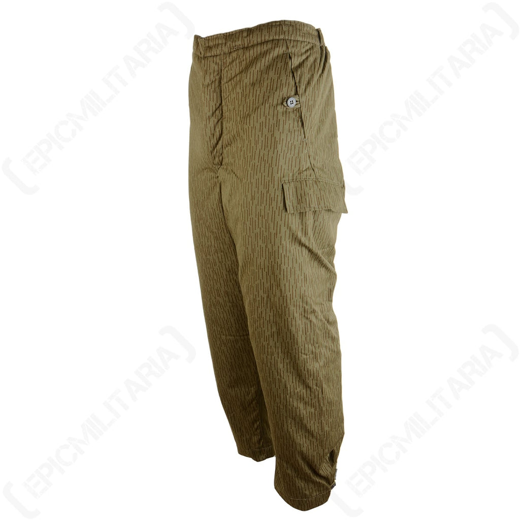 Angled side view of East German Strichtarn trousers highlighting the durable cotton blend fabric, hip pocket, and button-up utility features.