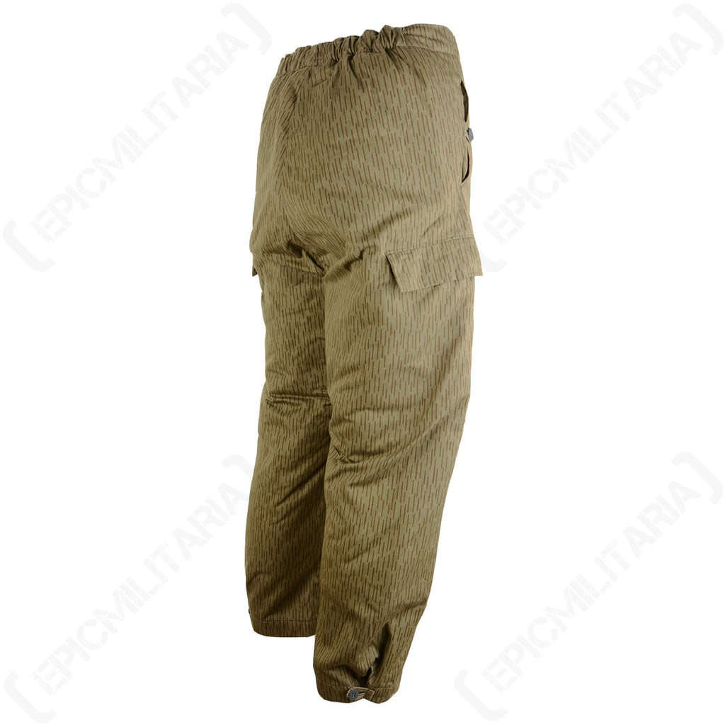 Rear angled view of East German Strichtarn winter trousers showing the spacious cargo-style leg pockets and thick padded insulation.