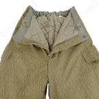Internal view of East German Strichtarn winter trousers displaying the quilted polyester padding, reinforced belt loops, and button fly closure.