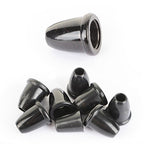 Close-up of a small pile of British Army black cord end stoppers displaying their versatile bell shape for gear maintenance.