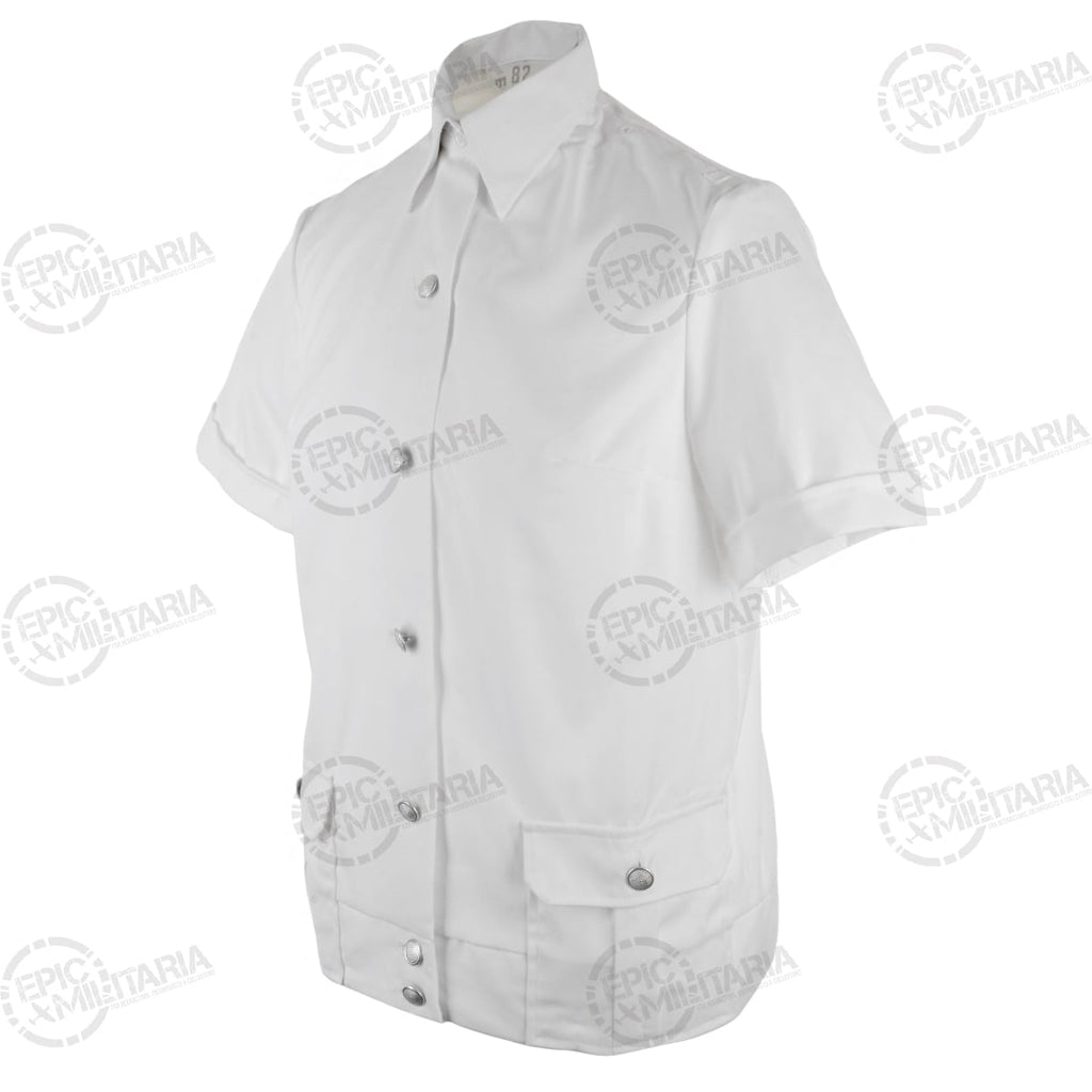 Three-quarter angle of an authentic DDR surplus white short-sleeve police shirt featuring metal buttons and scalloped pocket flaps.