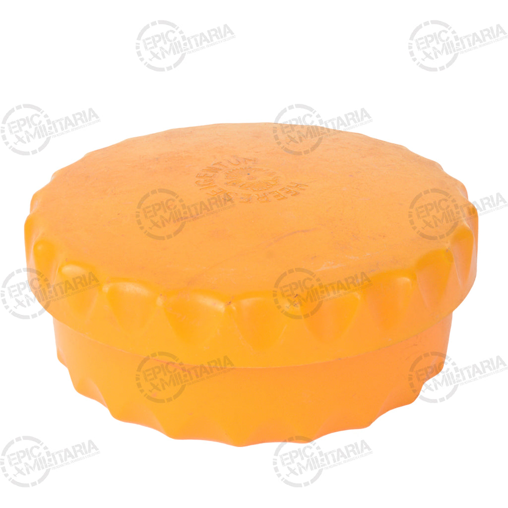 Close-up of a circular orange Austrian Army butter dish featuring a textured, scalloped bottle-cap design lid.