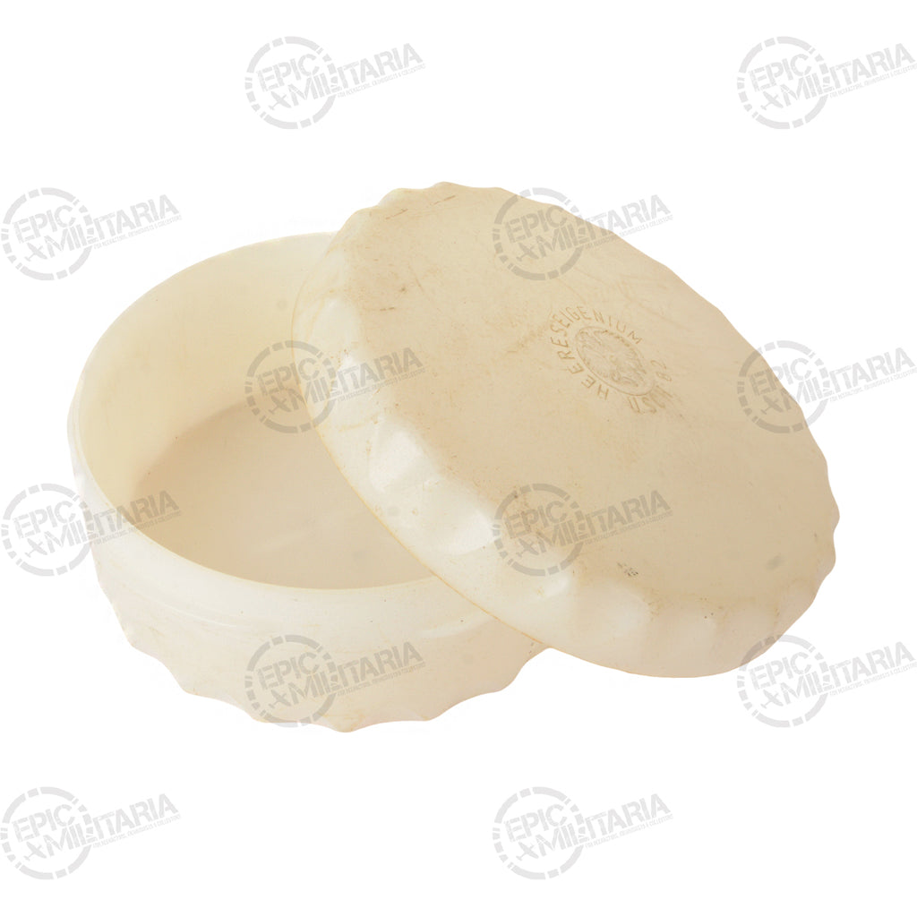Open cream-colored Austrian Army butter dish displaying the locking lid mechanism and sturdy hard plastic construction.