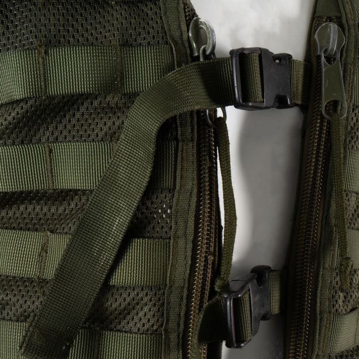 Close-up of the green front zippers and heavy-duty quick-release plastic buckles