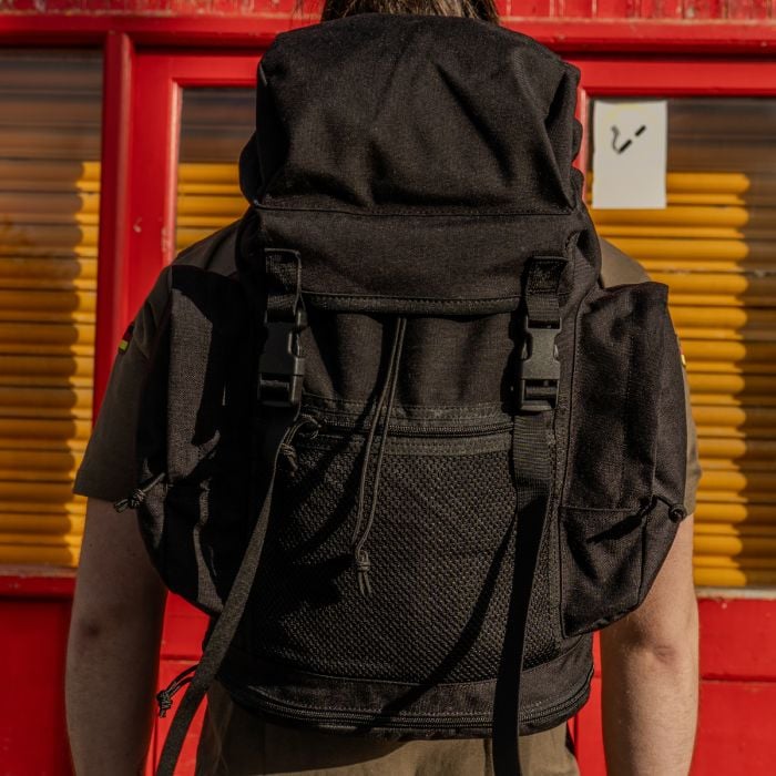 Original British Army Black Day Sack worn by user showing back fit and side profile