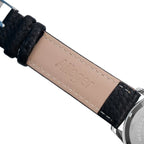 Close-up of the stamped Wasserdicht Stahlboden caseback and Ailager branded inner strap